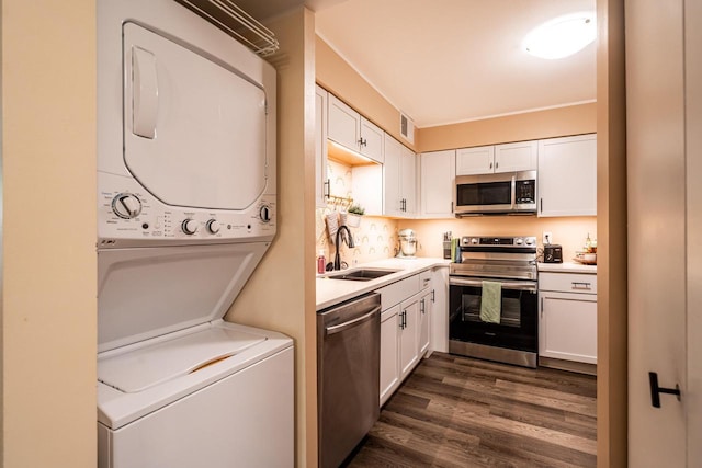 1906 E Shorewood Blvd Unit 250, Shorewood, WI 53211 - kitchen with stainless steel appliances, estacked washer and dryer, white cabinets, light countertops, and dark wood finished floors