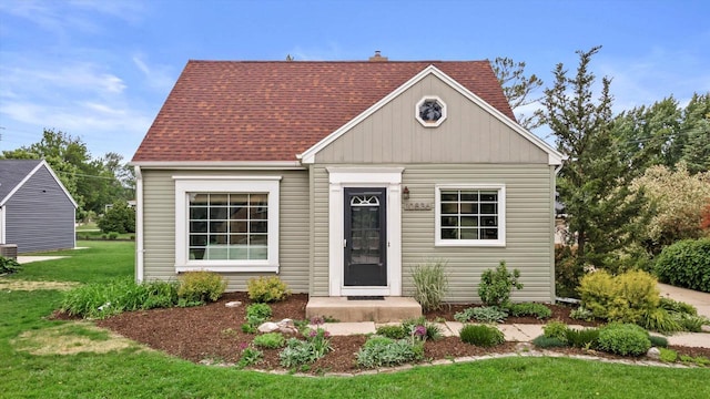 10836 W Fiebrantz Ave, Wauwatosa, WI 53222 - view of front facade featuring a front lawn and a shingled roof