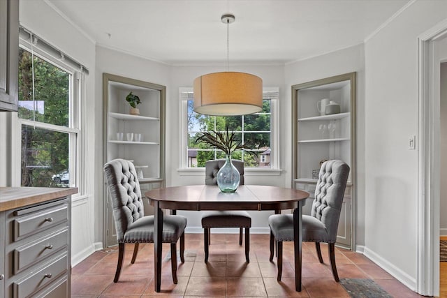 10836 W Fiebrantz Ave, Wauwatosa, WI 53222 - dining area with built in features, plenty of natural light, ornamental molding, and dark tile patterned flooring