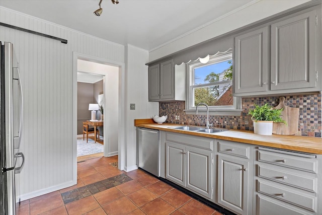 10836 W Fiebrantz Ave, Wauwatosa, WI 53222 - kitchen with stainless steel appliances, gray cabinets, butcher block countertops, backsplash, and crown molding