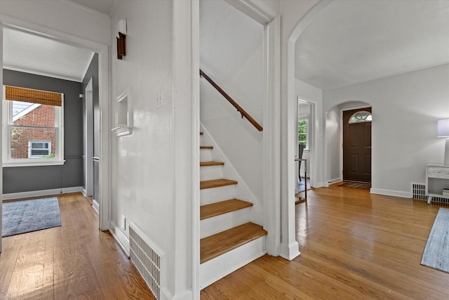 10836 W Fiebrantz Ave, Wauwatosa, WI 53222 - entrance foyer featuring arched walkways, wood finished floors, and stairway
