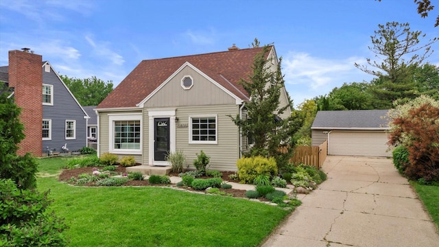 10836 W Fiebrantz Ave, Wauwatosa, WI 53222 - view of front of property featuring an outdoor structure, a garage, and roof with shingles