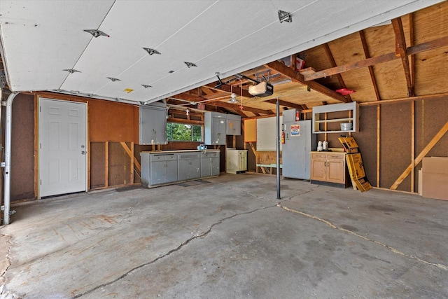10836 W Fiebrantz Ave, Wauwatosa, WI 53222 - garage with freestanding refrigerator, a garage door opener, and washer / dryer