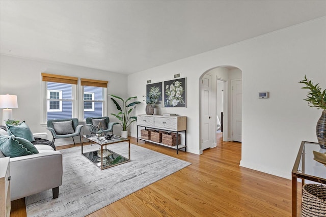 10836 W Fiebrantz Ave, Wauwatosa, WI 53222 - living room featuring arched walkways and light wood-style flooring