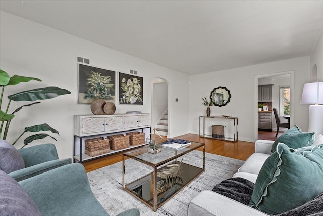 10836 W Fiebrantz Ave, Wauwatosa, WI 53222 - living room with arched walkways, wood finished floors, and stairs