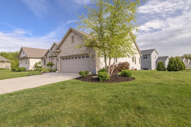 12907 78th Pl, Bristol, WI 53104 - view of front of property featuring an attached garage, concrete driveway, a front yard, and stone siding