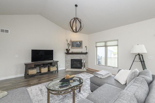 12907 78th Pl, Bristol, WI 53104 - living area featuring wood finished floors, lofted ceiling, a chandelier, and a fireplace