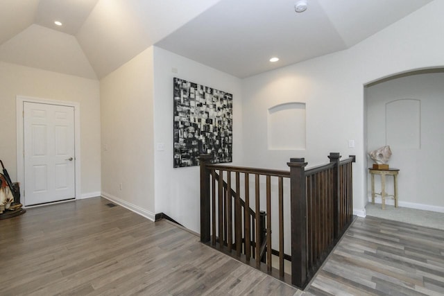 12907 78th Pl, Bristol, WI 53104 - hallway featuring wood finished floors, an upstairs landing, arched walkways, recessed lighting, and vaulted ceiling