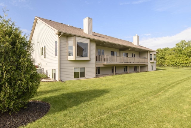 12907 78th Pl, Bristol, WI 53104 - back of property with a chimney, a yard, and a balcony