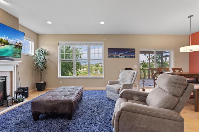 9414 Harvest Moon Ln, Verona, WI 53593 - living room with plenty of natural light, a lit fireplace, recessed lighting, and wood finished floors