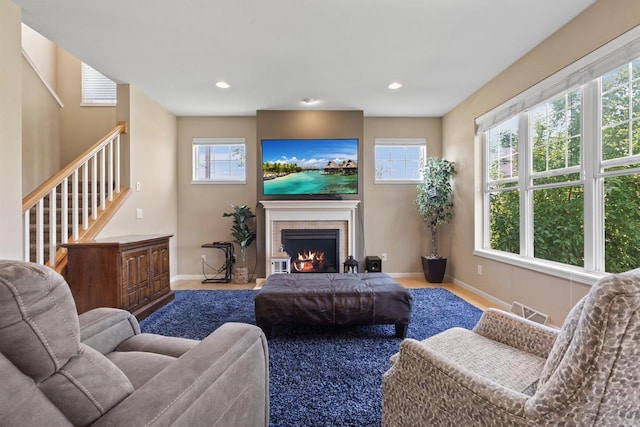 9414 Harvest Moon Ln, Verona, WI 53593 - living area with a tiled fireplace, stairway, and recessed lighting