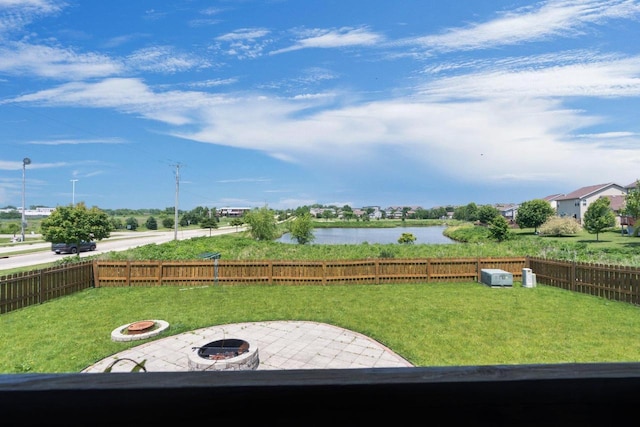 9414 Harvest Moon Ln, Verona, WI 53593 - fenced backyard with a fire pit, a patio area, and a water view
