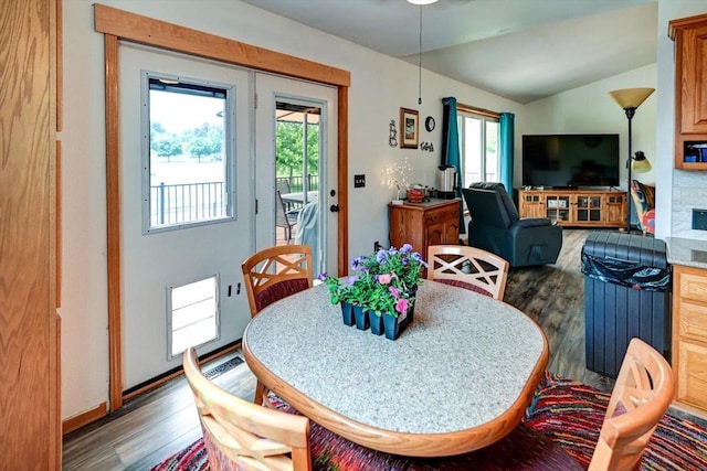 830 Violet Ln, Oregon, WI 53575 - dining area featuring wood finished floors, healthy amount of natural light, and vaulted ceiling