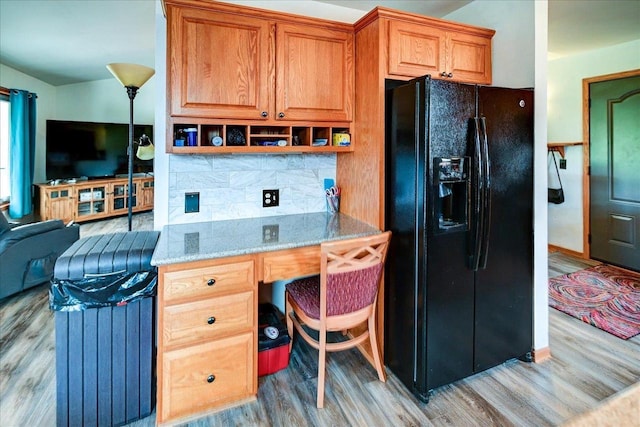 830 Violet Ln, Oregon, WI 53575 - kitchen featuring black refrigerator with ice dispenser, light wood-type flooring, tasteful backsplash, and light stone counters