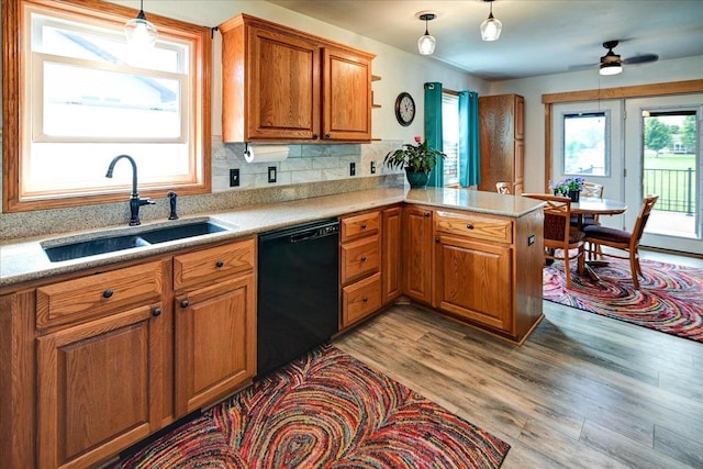 830 Violet Ln, Oregon, WI 53575 - kitchen with dishwasher, a peninsula, plenty of natural light, and brown cabinets