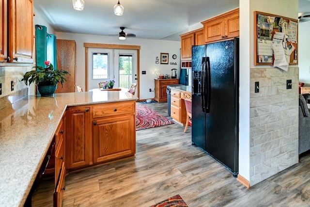 830 Violet Ln, Oregon, WI 53575 - kitchen featuring black refrigerator with ice dispenser, a peninsula, a ceiling fan, and light wood-style flooring
