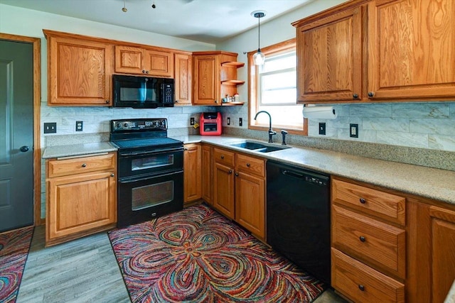 830 Violet Ln, Oregon, WI 53575 - kitchen featuring black appliances, brown cabinetry, and decorative backsplash
