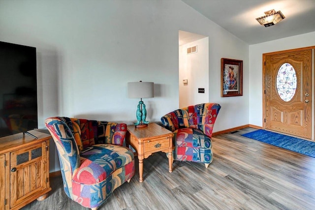 830 Violet Ln, Oregon, WI 53575 - living area featuring wood finished floors and lofted ceiling
