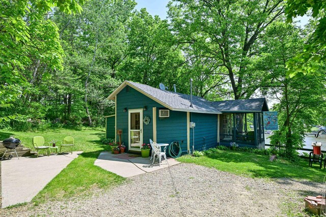 9034 N County Road F, Edgerton, WI 53534 - view of outdoor structure featuring a sunroom and a wall mounted air conditioner
