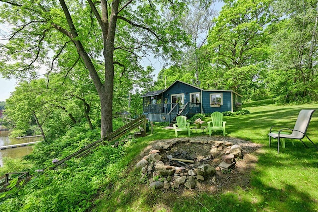 9034 N County Road F, Edgerton, WI 53534 - view of green lawn featuring an outdoor fire pit and a wooden deck