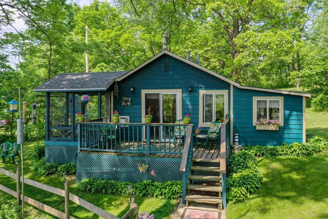 9034 N County Road F, Edgerton, WI 53534 - view of front of house featuring a wooden deck and a front lawn