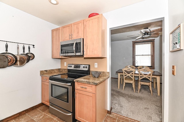 2517 Ashland Ave, Racine, WI 53403 - kitchen with stainless steel appliances, light brown cabinetry, and ceiling fan