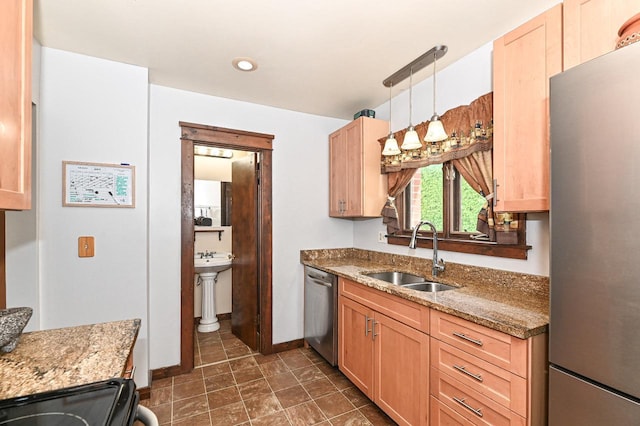 2517 Ashland Ave, Racine, WI 53403 - kitchen with appliances with stainless steel finishes, light brown cabinets, stone countertops, and decorative light fixtures