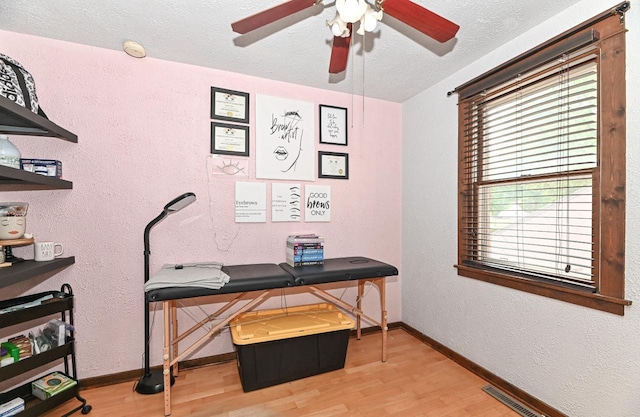 2517 Ashland Ave, Racine, WI 53403 - office featuring wood finished floors, a ceiling fan, a textured wall, and a textured ceiling