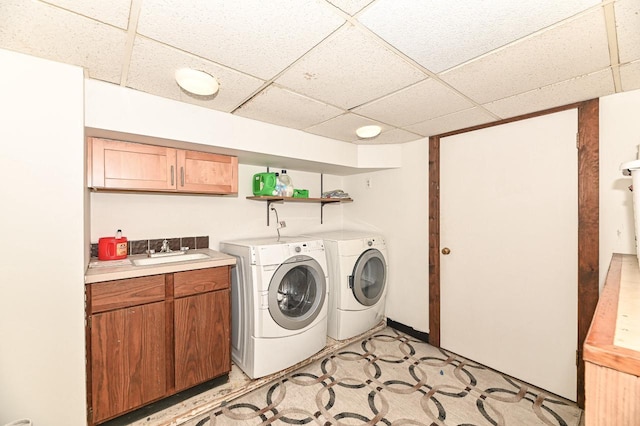 2517 Ashland Ave, Racine, WI 53403 - laundry area with washer and dryer, cabinet space, and light flooring