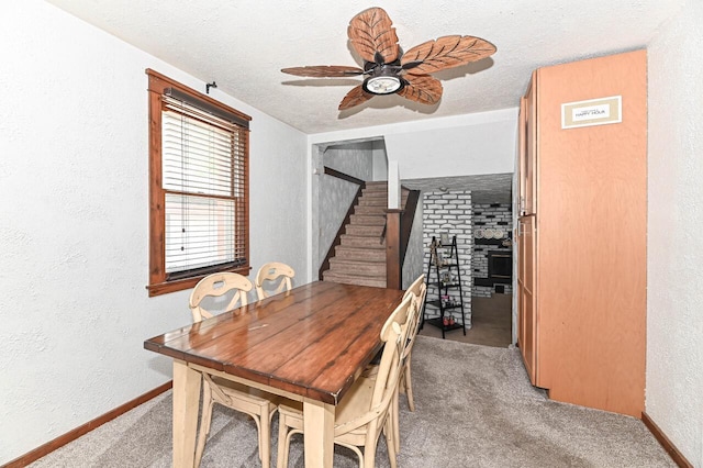 2517 Ashland Ave, Racine, WI 53403 - dining area with carpet, ceiling fan, stairs, a textured wall, and a textured ceiling
