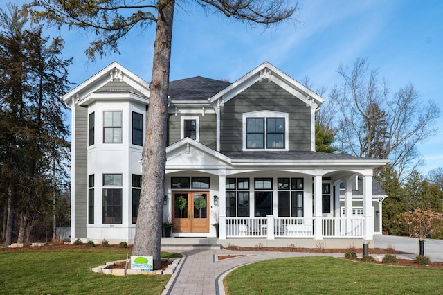 545 Wisconsin Ave, Delafield, WI 53018 - view of front facade with a porch, a front yard, and roof with shingles