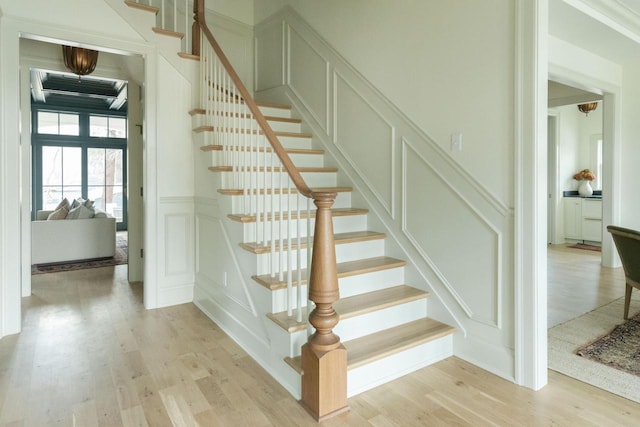545 Wisconsin Ave, Delafield, WI 53018 - staircase with a decorative wall, wood finished floors, and a wainscoted wall