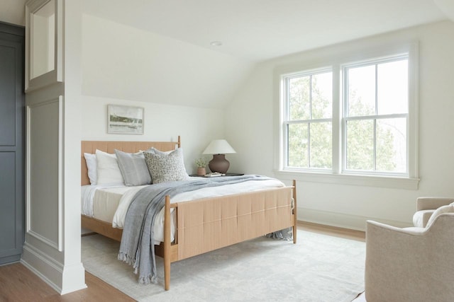 545 Wisconsin Ave, Delafield, WI 53018 - bedroom featuring light wood-style floors and lofted ceiling