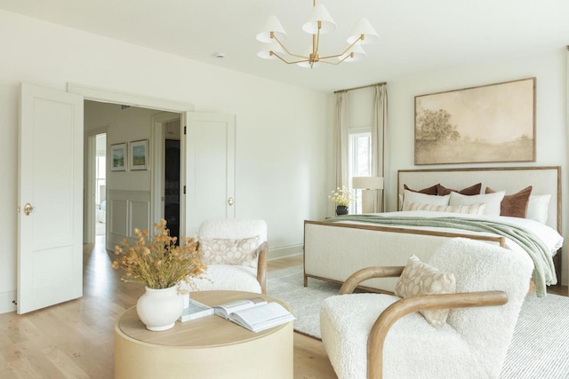 545 Wisconsin Ave, Delafield, WI 53018 - bedroom featuring a chandelier and light wood-type flooring