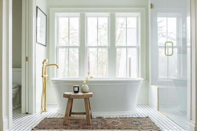 545 Wisconsin Ave, Delafield, WI 53018 - bathroom with a shower stall, tile patterned floors, and a soaking tub
