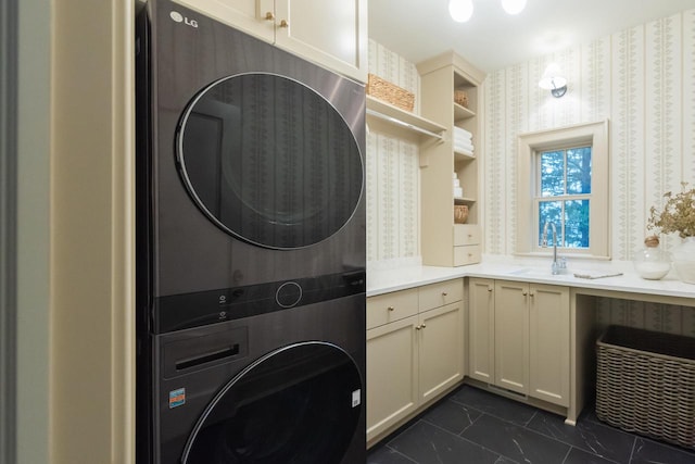 545 Wisconsin Ave, Delafield, WI 53018 - washroom with stacked washer and clothes dryer, cabinet space, wallpapered walls, and dark marble finish floors