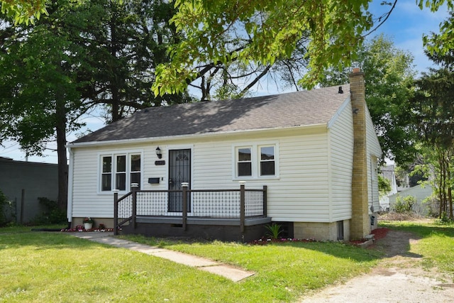 4821 N 58th St, Milwaukee, WI 53218 - bungalow with a front yard, a chimney, and a shingled roof