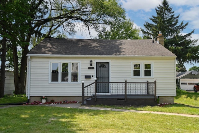 4821 N 58th St, Milwaukee, WI 53218 - view of front of property featuring a chimney, a front lawn, and a shingled roof