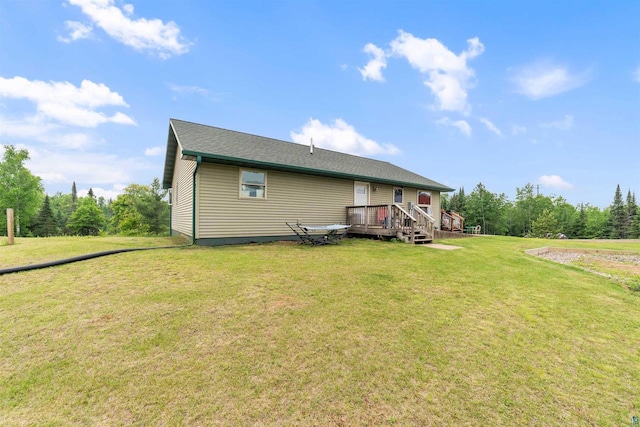 7684 E Moose Lake Rd, Solon Springs, WI 54873 - back of property with a wooden deck and a yard