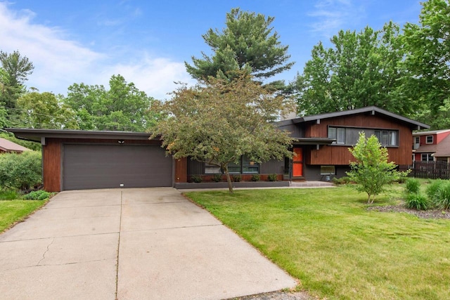 24 Hazelwood Dr, Stevens Point, WI 54481 - tri-level home with driveway, a front lawn, and an attached garage