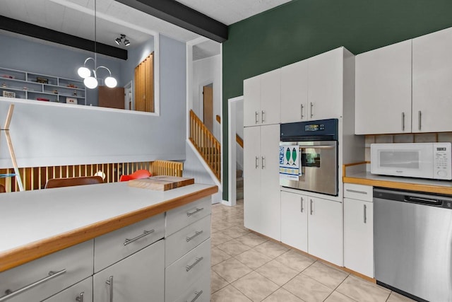 24 Hazelwood Dr, Stevens Point, WI 54481 - kitchen with stainless steel appliances, light countertops, white cabinets, and decorative light fixtures