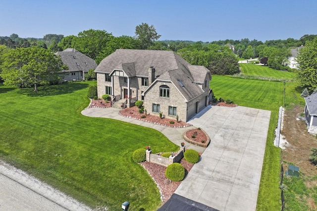 1434 43rd Ave, Kenosha, WI 53144 - view of front of house featuring stone siding, concrete driveway, a garage, and a front yard