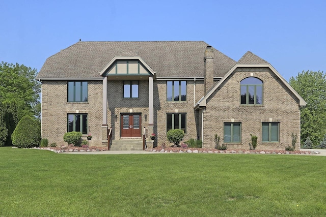 1434 43rd Ave, Kenosha, WI 53144 - view of front of house with a front lawn, brick siding, french doors, and roof with shingles