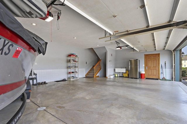 1434 43rd Ave, Kenosha, WI 53144 - garage with freestanding refrigerator, a garage door opener, and recessed lighting