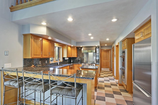 1434 43rd Ave, Kenosha, WI 53144 - kitchen with appliances with stainless steel finishes, a peninsula, recessed lighting, backsplash, and a breakfast bar area