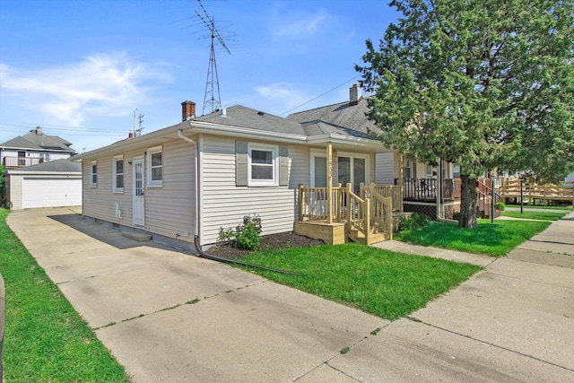 1933 Jay Eye See Ave, Racine, WI 53403 - bungalow-style home featuring an outbuilding, a chimney, a front yard, and a detached garage