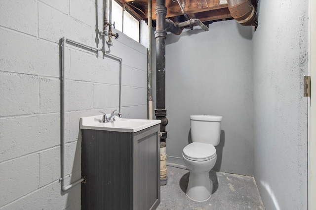 1933 Jay Eye See Ave, Racine, WI 53403 - bathroom featuring vanity, concrete block wall, and concrete floors