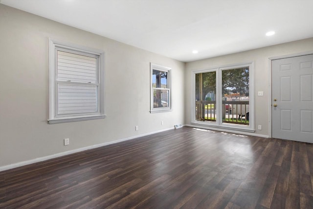 1933 Jay Eye See Ave, Racine, WI 53403 - unfurnished living room featuring dark wood-type flooring and recessed lighting