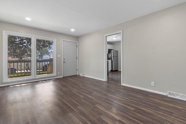 1933 Jay Eye See Ave, Racine, WI 53403 - spare room featuring dark wood-type flooring and recessed lighting