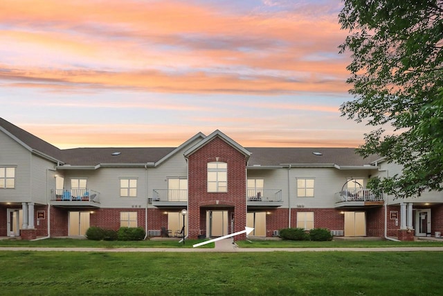 33A Grand Canyon Dr Unit 110, Baraboo, WI 53913 - view of property with brick siding, a front yard, and a balcony